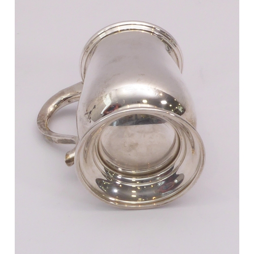 73 - A George VI silver pint tankard - G. Bryan & Co., Birmingham 1941, baluster form with scroll handle,... 