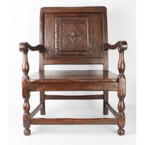 408 - An early 20th century carved oak low armchair in 17th century style - from St Arvans House, Monmouth... 