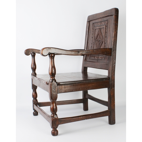 408 - An early 20th century carved oak low armchair in 17th century style - from St Arvans House, Monmouth... 