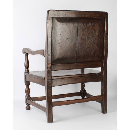 408 - An early 20th century carved oak low armchair in 17th century style - from St Arvans House, Monmouth... 