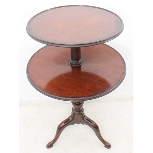 411 - A George III mahogany two-tier dumb waiter - of good colour, the two graduated, dished tiers revolvi... 