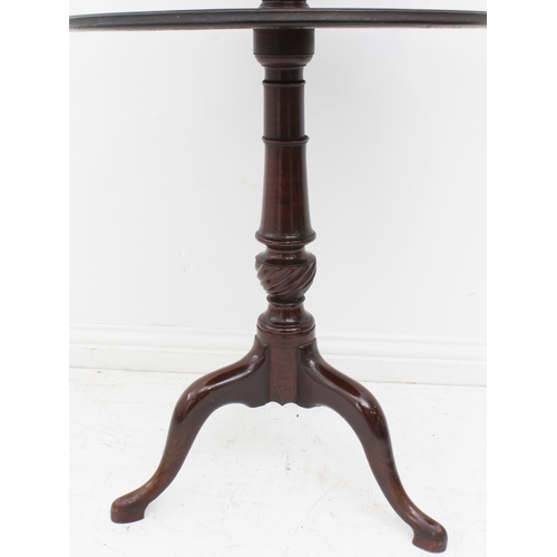 411 - A George III mahogany two-tier dumb waiter - of good colour, the two graduated, dished tiers revolvi... 