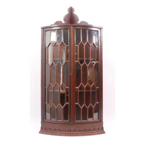 434 - A Georgian-style mahogany glazed hanging corner cabinet - early 20th century, the moulded cornice wi... 