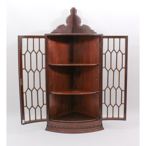 434 - A Georgian-style mahogany glazed hanging corner cabinet - early 20th century, the moulded cornice wi... 