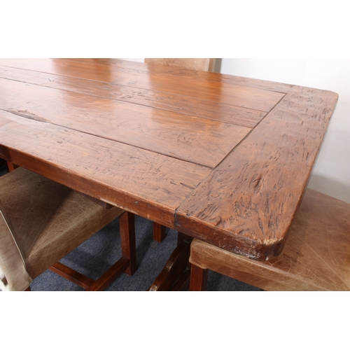 456 - A fine teak refectory-style dining table - the richly coloured, cleated, five-plank top on trestle e... 