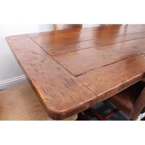 456 - A fine teak refectory-style dining table - the richly coloured, cleated, five-plank top on trestle e... 