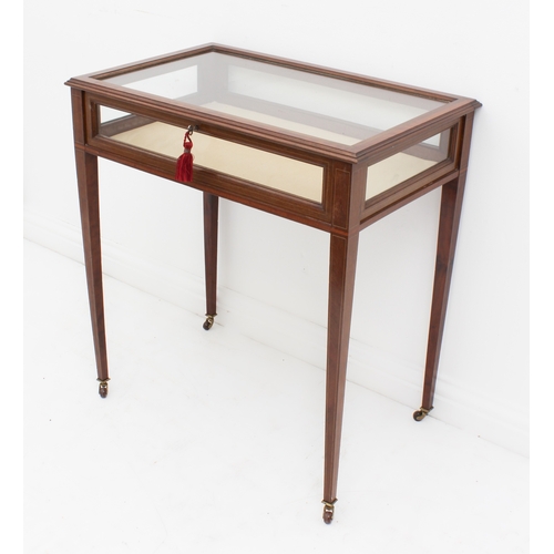 458 - An Edwardian mahogany and satinwood-crossbanded vitrine table - the hinged glazed top over glazed si... 