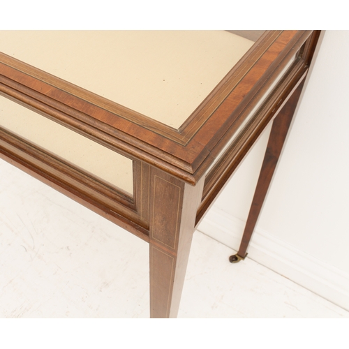 458 - An Edwardian mahogany and satinwood-crossbanded vitrine table - the hinged glazed top over glazed si... 