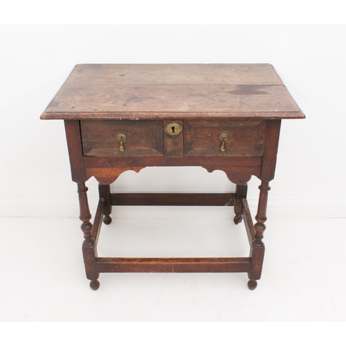 468 - An early 18th century joined oak single-drawer side table - the boarded, moulded top over a single d... 