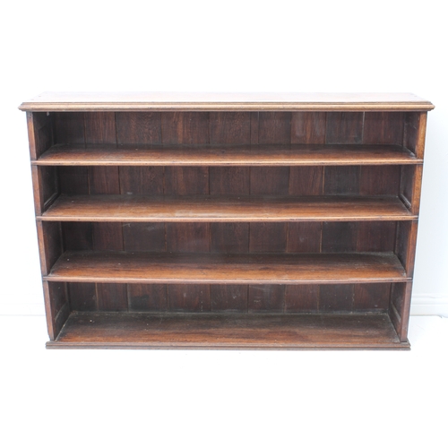 469 - A 19th century oak open bookcase - the moulded top over four graduated open shelves, the sides with ... 