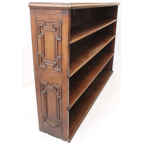 469 - A 19th century oak open bookcase - the moulded top over four graduated open shelves, the sides with ... 