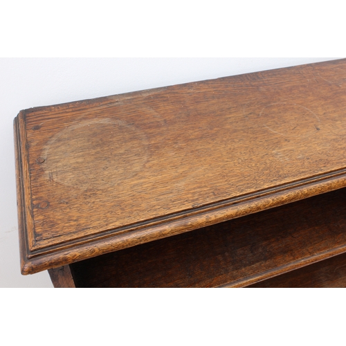 469 - A 19th century oak open bookcase - the moulded top over four graduated open shelves, the sides with ... 