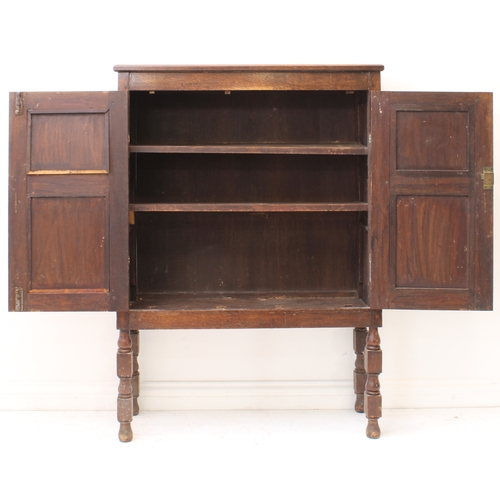 470 - A 19th century panelled oak cabinet on stand - the chamfered top over a pair of geometric mitre pane... 