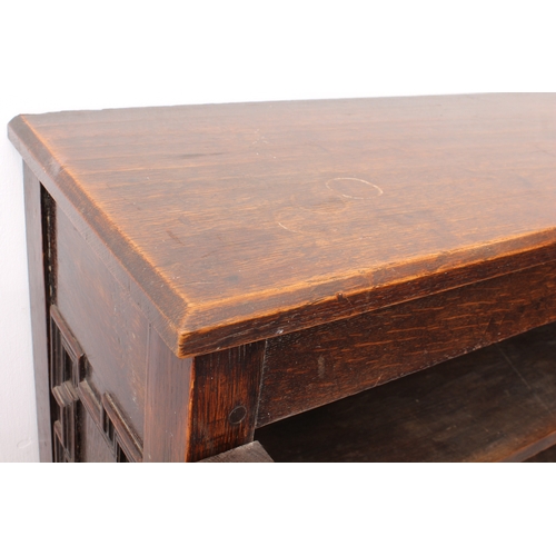 470 - A 19th century panelled oak cabinet on stand - the chamfered top over a pair of geometric mitre pane... 