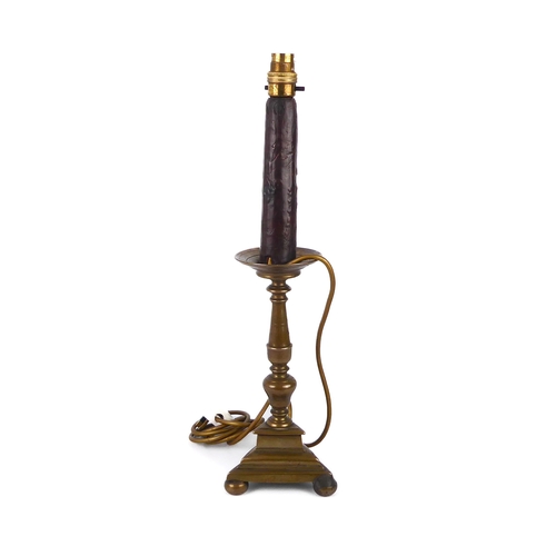 540 - A late-18th century brass tripod candlestick adapted as a table lamp, the trainagular base marked wi... 