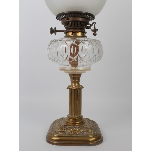 541 - An Edwardian brass and cut glass oil lamp by Hinks & Sons for Maple of London, the rounded square ba... 