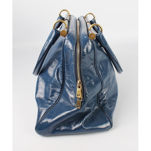 574 - A blue patent leather shoulder bag by Yves Saint Laurent - with brushed gold toned hardware, two bar... 