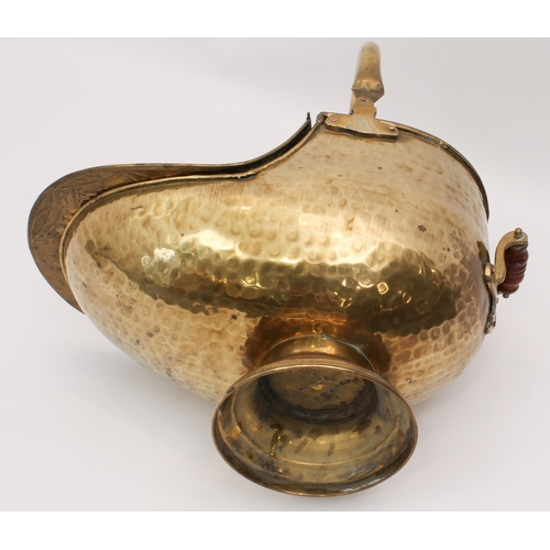 580 - A large early 20th century brass coal scuttle - embossed in the Art Nouveau manner, swing-handle and... 