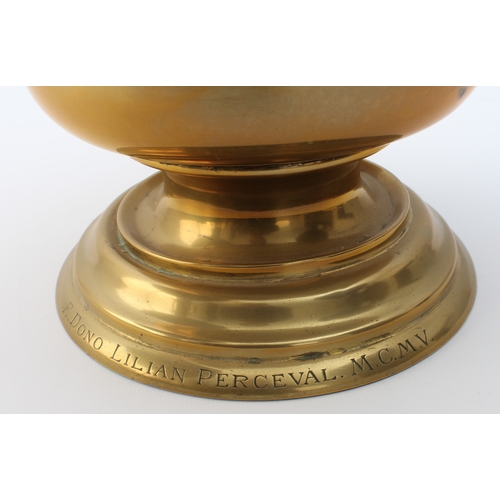 583 - A large Edwardian brass ewer in Arts & Crafts style - the girdled, bun-shaped body on a pedestal foo... 