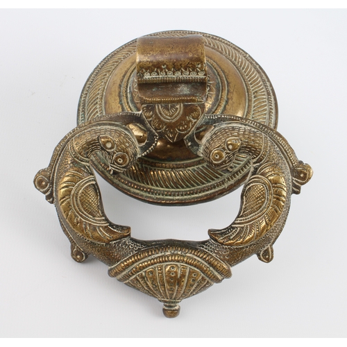 590 - An Indian brass door knocker, circular back plate 10.7 cm diameter.