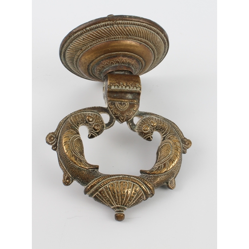 590 - An Indian brass door knocker, circular back plate 10.7 cm diameter.