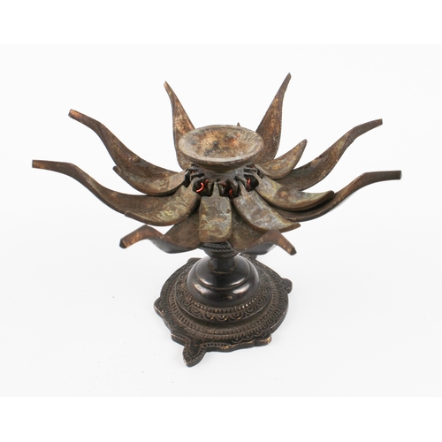 594 - A pair of patinated bronze lotus-form candle holders, possibly Tibetan - probably second half 20th c... 