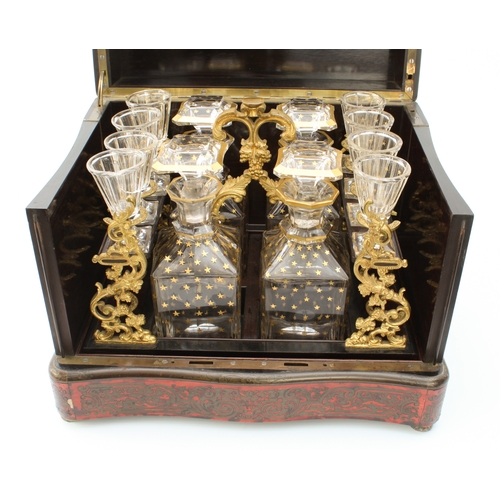 608 - An early 19th century French Boulle-style cave à liqueur or travelling decanter set - the serpentine... 