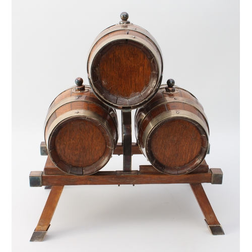 609 - A coopered oak and silver-plated three-barrel tabletop spirit dispenser stand - early 20th century, ... 