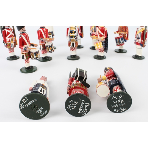 653 - Thirteen R&M Kirby Canadian hand-made, hand-painted wooden soldiers - each signed and numbered on ba... 