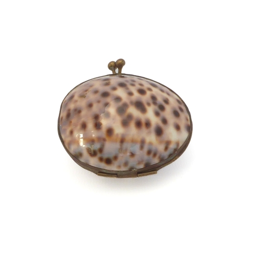 657 - A 19th century gilt-metal and cowrie shell box / purse, 6 cm long.