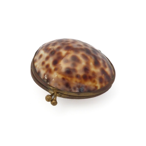 657 - A 19th century gilt-metal and cowrie shell box / purse, 6 cm long.