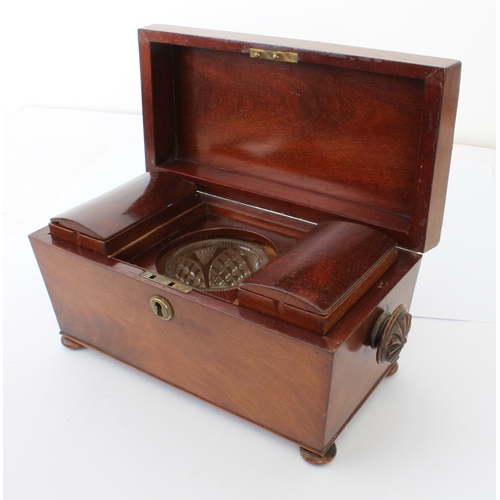 676 - A mid-19th century mahogany sarcophagus tea caddy - with fan carved handles and turned bun feet, the... 