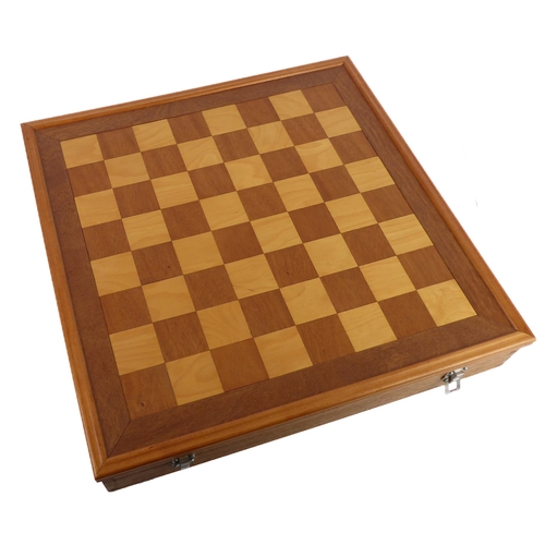 678 - A custom-made chess boxset, the board secured by toggle-latches and serving as a lid. The interior f... 