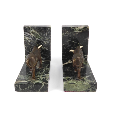 679 - A pair of bronze and marble bookends - second half 20th century, the bulls with mid-brown and golden... 