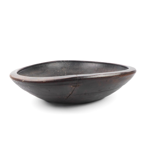 680 - A large turned wooden bowl, probably African - mid-20th century, one side with a copper wire stitche... 