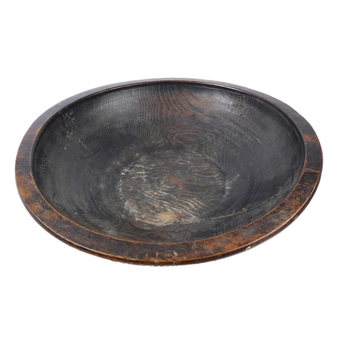 680 - A large turned wooden bowl, probably African - mid-20th century, one side with a copper wire stitche... 