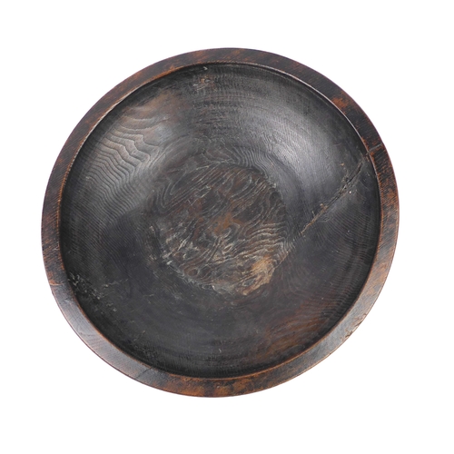 680 - A large turned wooden bowl, probably African - mid-20th century, one side with a copper wire stitche... 