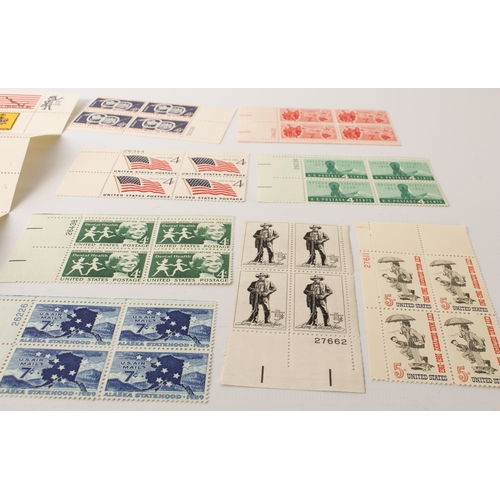 699 - A large collection of stamps:
 a stock album containing 71 USA blocks of four (mostly 1960-1980);
 2... 