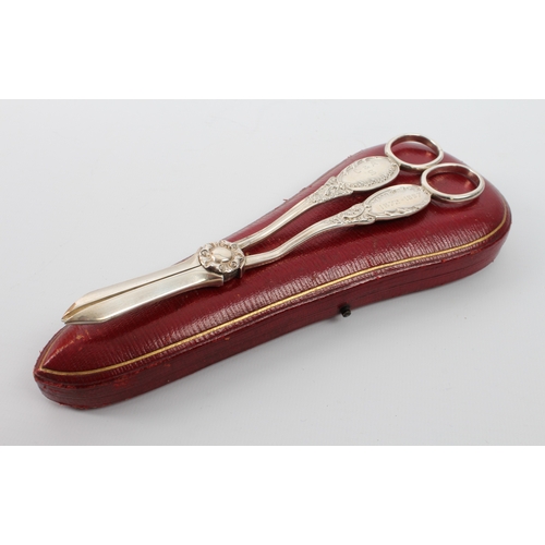 153 - A cased pair of late Victorian silver grape scissors - Mappin & Webb, Sheffield 1896, with rose-form... 