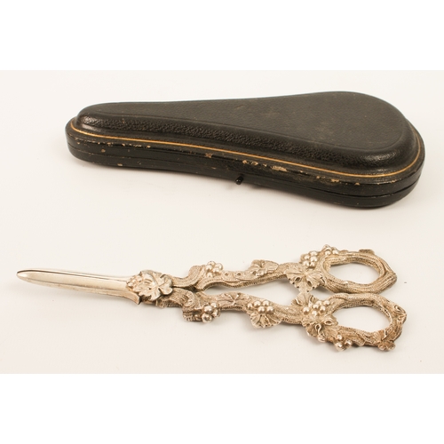 154 - A cased pair of Edwardian silver grape scissors - William Hutton & Sons Ltd., London 1909, the vine-... 