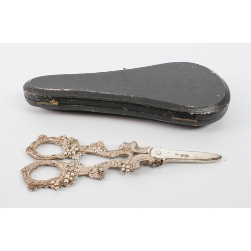 154 - A cased pair of Edwardian silver grape scissors - William Hutton & Sons Ltd., London 1909, the vine-... 