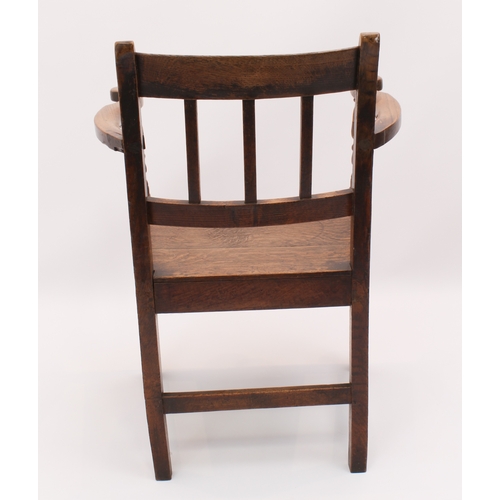 412 - A George III oak elbow chair - with three-rail back, solid seat, swept arms and tapered square legs ... 