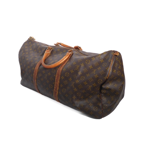 571 - A vintage Louis Vuitton holdall or weekend bag - in classic monogram canvas with tan leather handles... 