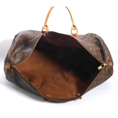 571 - A vintage Louis Vuitton holdall or weekend bag - in classic monogram canvas with tan leather handles... 