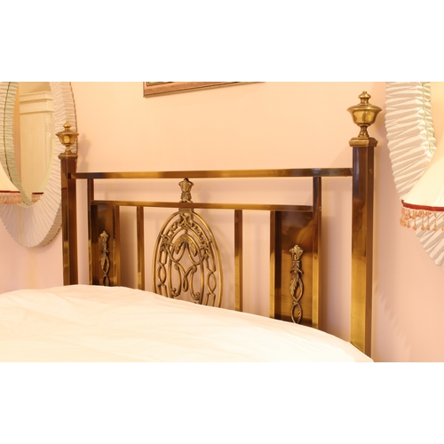 488 - An antiqued brass double bed in the 19th century style - the head and foot boards with central decor... 