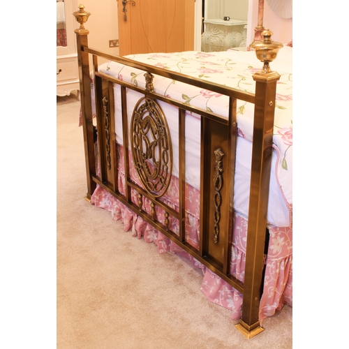 488 - An antiqued brass double bed in the 19th century style - the head and foot boards with central decor... 