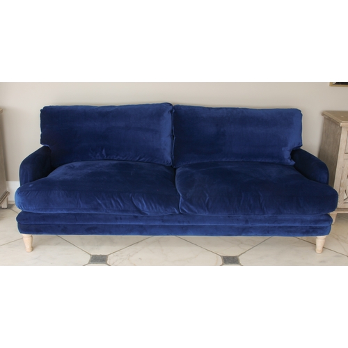 498 - A Loaf Squisheroo three seater settee - upholstered in Royal blue velvet, raised on turned limed oak... 