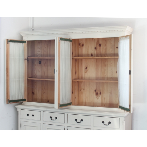 419 - A painted pine glazed dresser or library bookcase - painted off-white, the flared dentil cornice ove... 