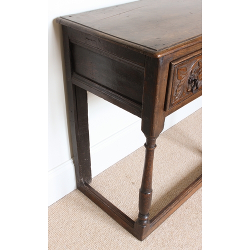 453 - An early 18th century and later joined oak dresser base of small proportions - the moulded, single p... 