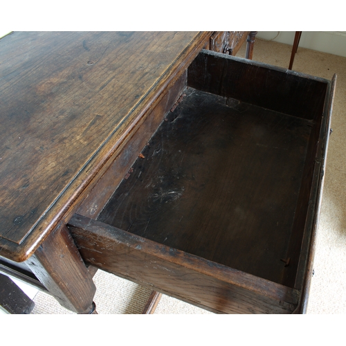 453 - An early 18th century and later joined oak dresser base of small proportions - the moulded, single p... 